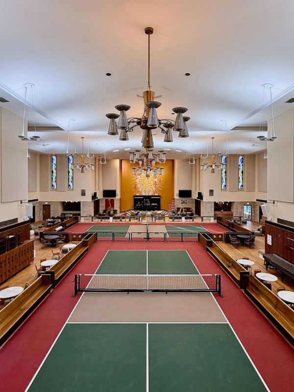 Indoor pickleball courts inside renovated church building at Church of Pickleball sports facility in Chicago Illinois